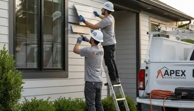 Technician repairing damaged vinyl siding on home exterior in Vancouver, WA